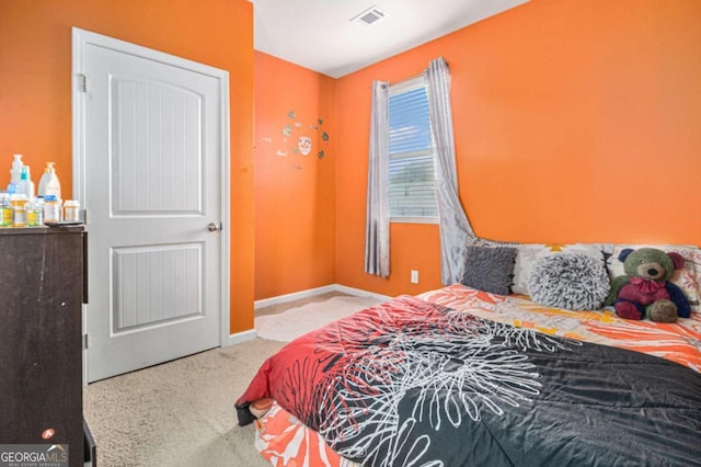 carpeted bedroom with visible vents and baseboards