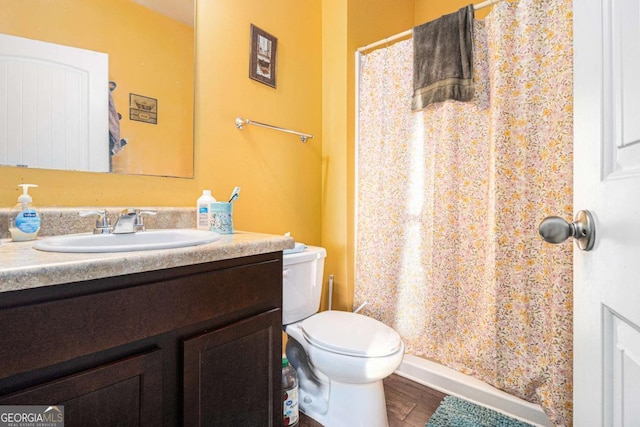 full bathroom featuring toilet, wood finished floors, vanity, and a shower with curtain