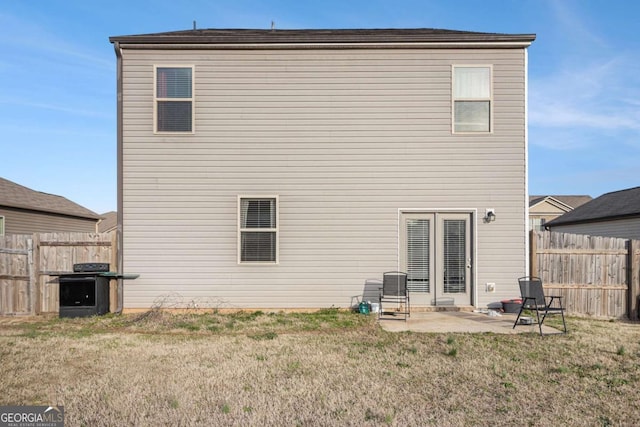 rear view of property with a patio area, fence, and a yard