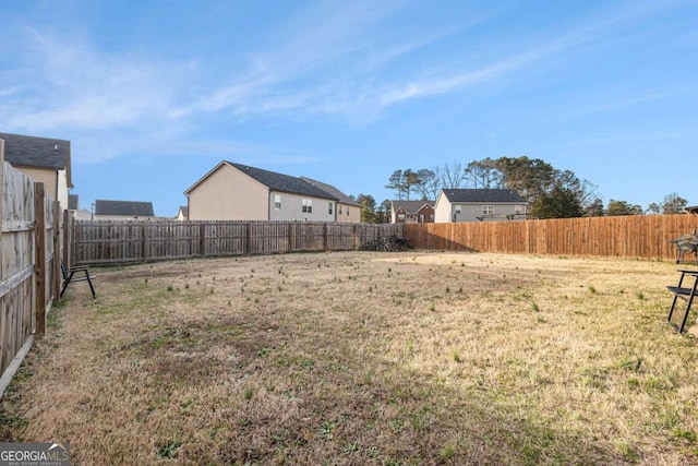 view of yard with a fenced backyard