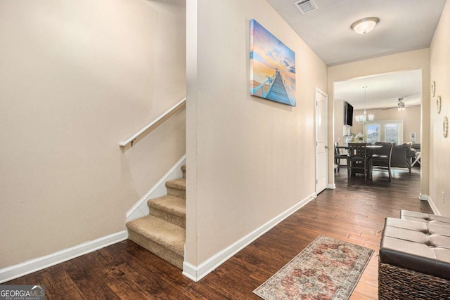 stairs with hardwood / wood-style flooring, baseboards, and visible vents