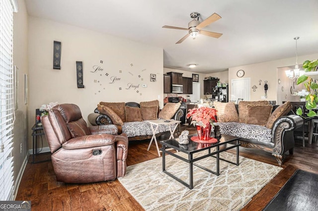 living room featuring dark wood-style floors and ceiling fan with notable chandelier