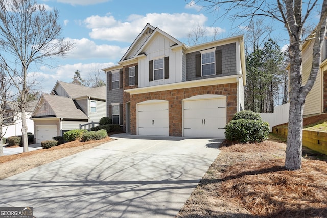 view of front of property featuring an attached garage, board and batten siding, fence, stone siding, and driveway