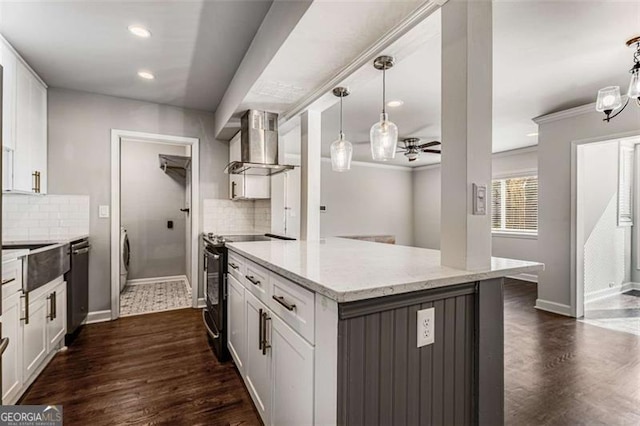 kitchen featuring dark wood-style floors, black electric range, stainless steel dishwasher, white cabinetry, and wall chimney exhaust hood