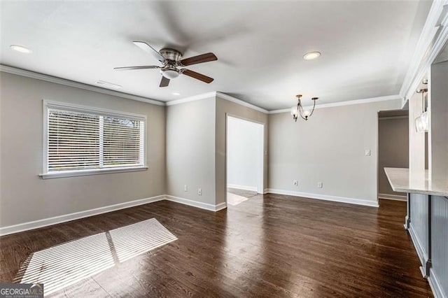 spare room with baseboards, dark wood-type flooring, and ceiling fan with notable chandelier