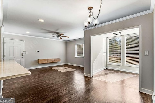 interior space featuring recessed lighting, dark wood-type flooring, a ceiling fan, baseboards, and crown molding