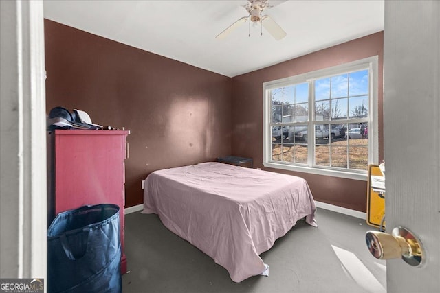 bedroom featuring ceiling fan and baseboards