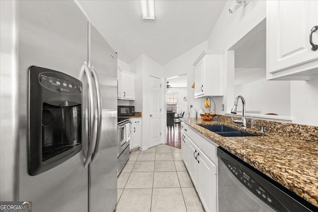 kitchen featuring appliances with stainless steel finishes, a sink, and white cabinetry