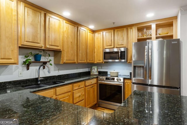 kitchen with stainless steel appliances, dark stone counters, open shelves, and a sink