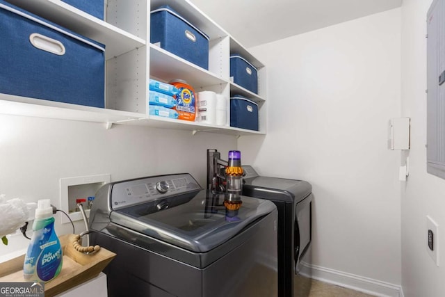 washroom with laundry area, washer and clothes dryer, and baseboards