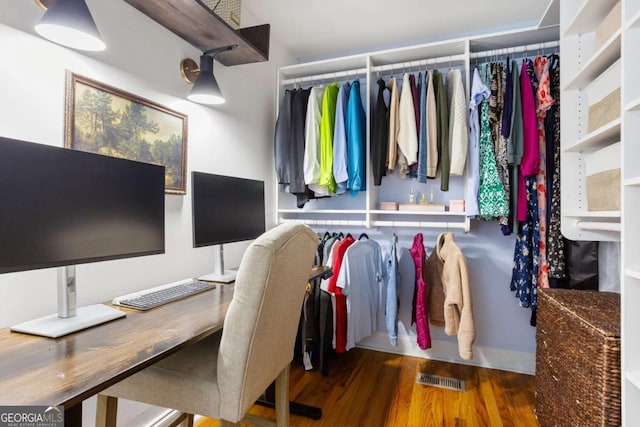 spacious closet featuring visible vents and wood finished floors