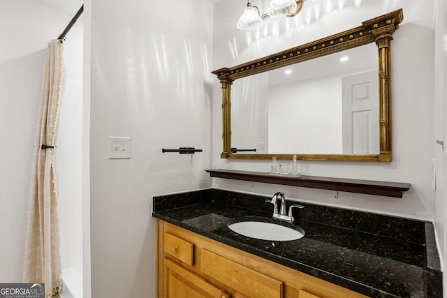 bathroom featuring curtained shower and vanity