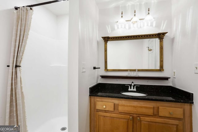 full bath with a stall shower and vanity