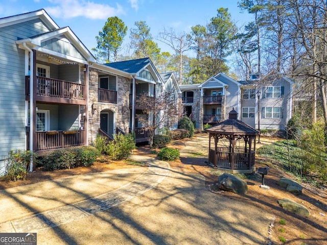 view of front of house with stone siding and a gazebo