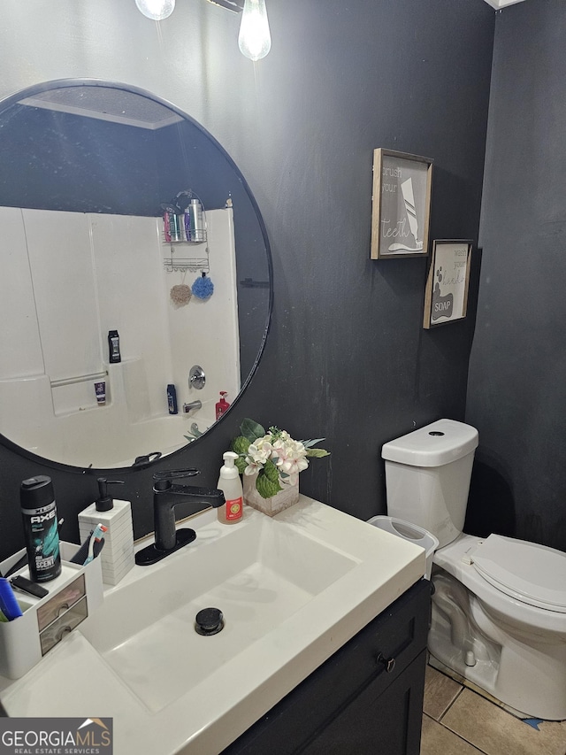 bathroom featuring toilet, vanity, and tile patterned floors