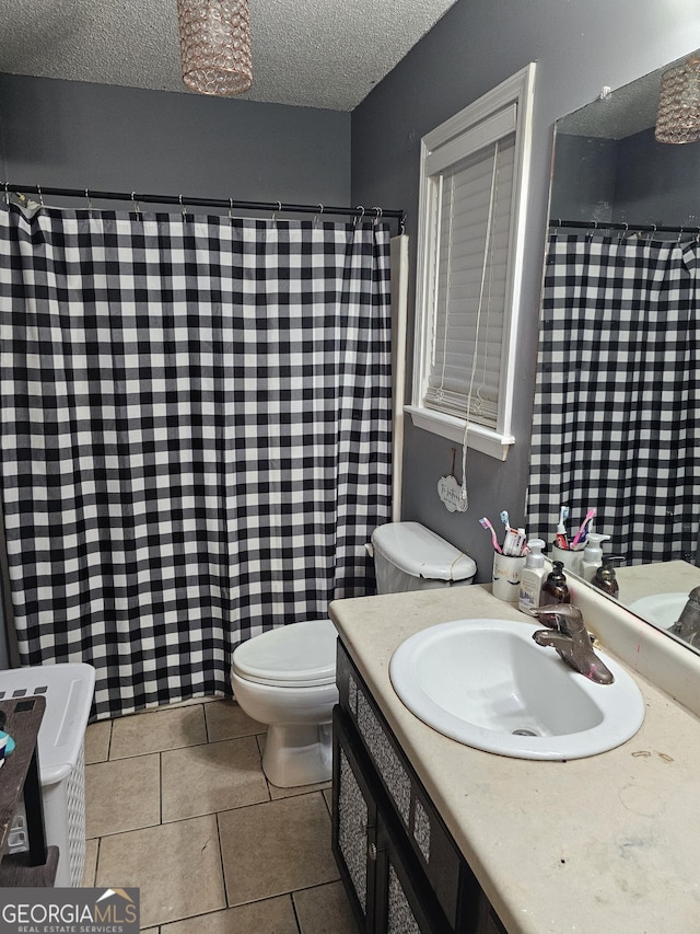 bathroom featuring a textured ceiling, tile patterned flooring, toilet, a shower with shower curtain, and vanity