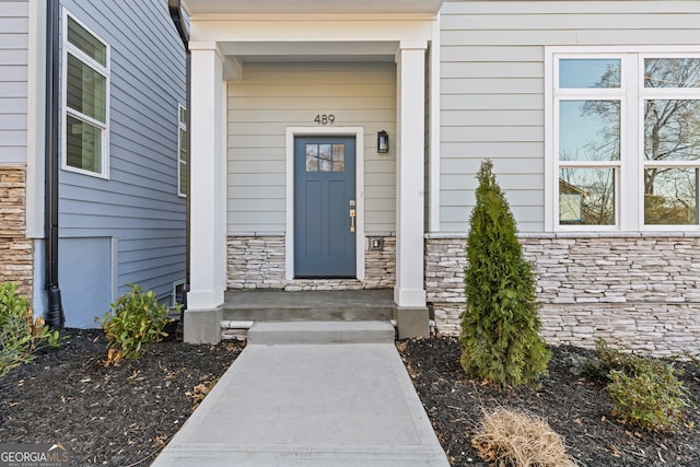 entrance to property with stone siding