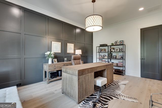 office featuring recessed lighting, a decorative wall, visible vents, ornamental molding, and light wood-type flooring