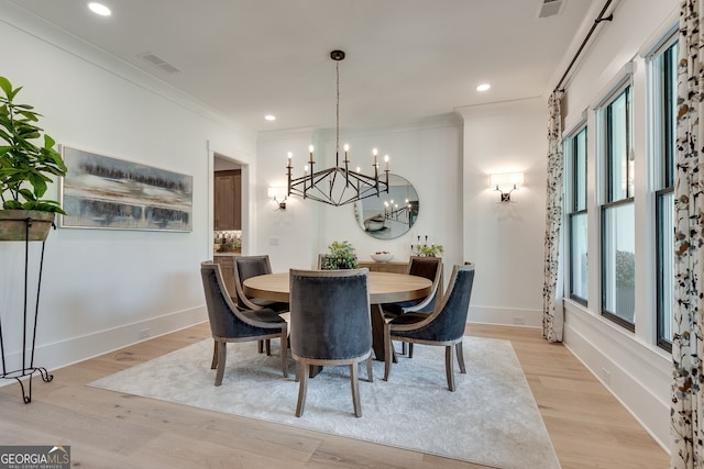 dining space with baseboards, light wood-style flooring, visible vents, and crown molding