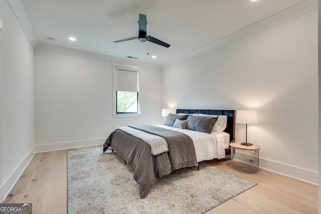 bedroom featuring recessed lighting, baseboards, wood finished floors, visible vents, and ornamental molding
