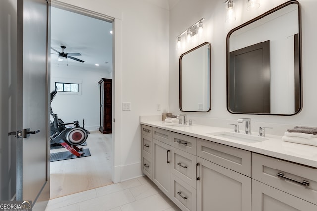 full bath featuring baseboards, a sink, ceiling fan, and double vanity