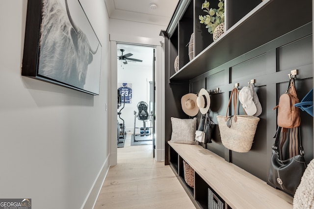 mudroom featuring ornamental molding, ceiling fan, baseboards, and wood finished floors