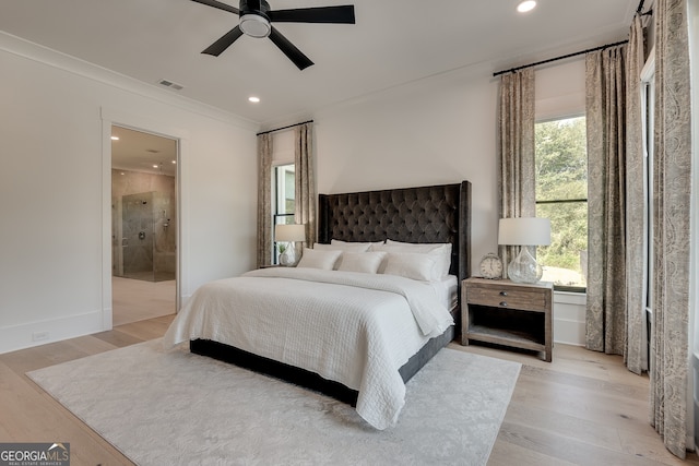 bedroom featuring visible vents, multiple windows, and light wood-style flooring