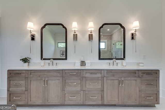 full bath with double vanity, a shower stall, and a sink