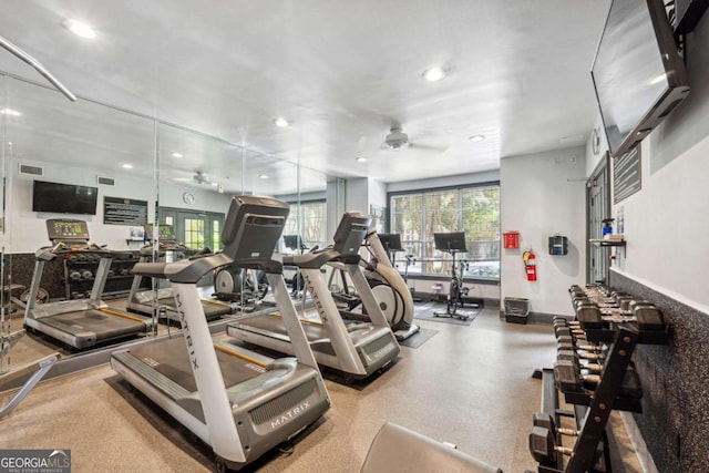 workout area featuring visible vents, ceiling fan, and a wealth of natural light