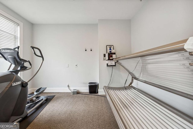 workout room with carpet floors and baseboards