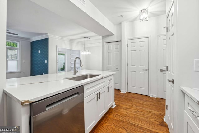 kitchen featuring light countertops, white cabinetry, a sink, wood finished floors, and dishwasher