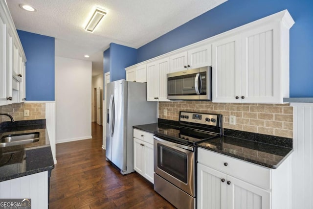 kitchen featuring white cabinetry, stainless steel appliances, and a sink