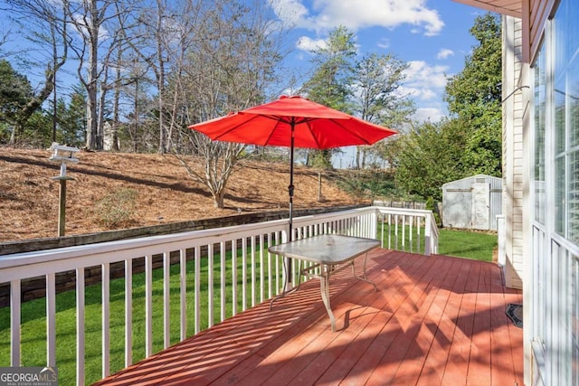 wooden terrace featuring a storage shed, an outdoor structure, and a yard