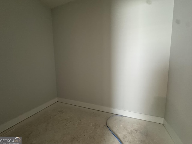 unfurnished room featuring baseboards