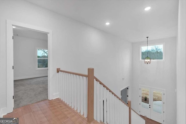 interior space featuring a chandelier, a wealth of natural light, an upstairs landing, and recessed lighting