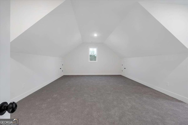 bonus room featuring carpet floors, baseboards, and vaulted ceiling