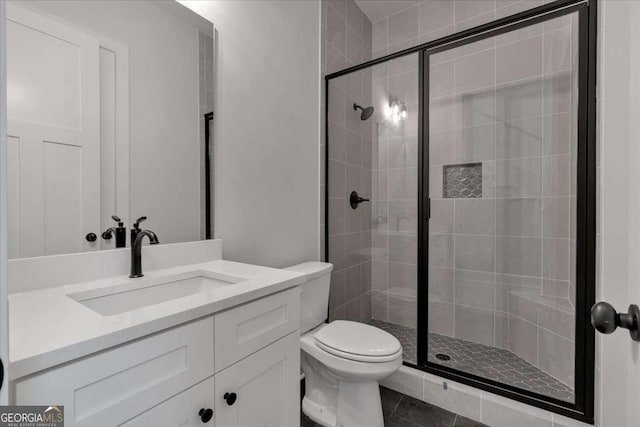 full bathroom with toilet, a shower stall, and vanity