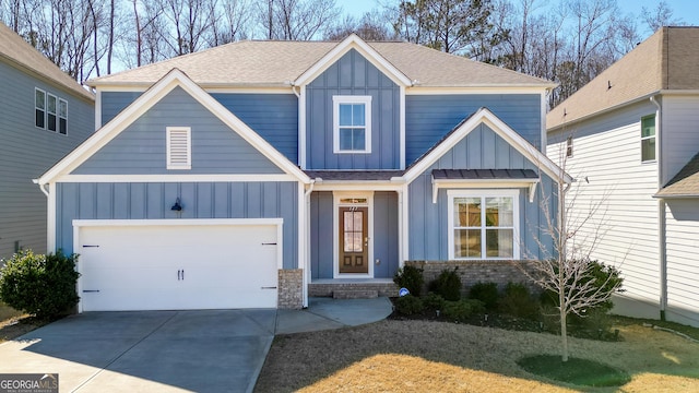 view of front of home with concrete driveway, roof with shingles, an attached garage, board and batten siding, and brick siding