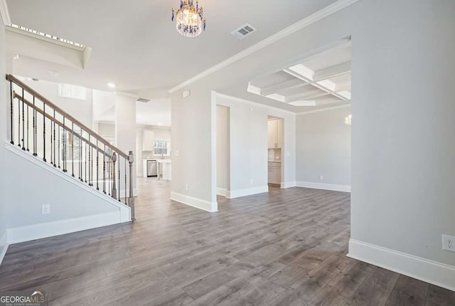 interior space featuring a chandelier, coffered ceiling, visible vents, and wood finished floors