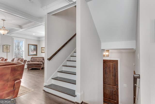 stairway with coffered ceiling, ornamental molding, wood finished floors, beam ceiling, and recessed lighting