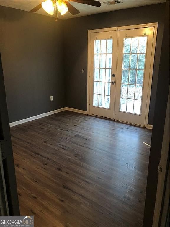 entryway featuring dark wood-style flooring, french doors, visible vents, ceiling fan, and baseboards