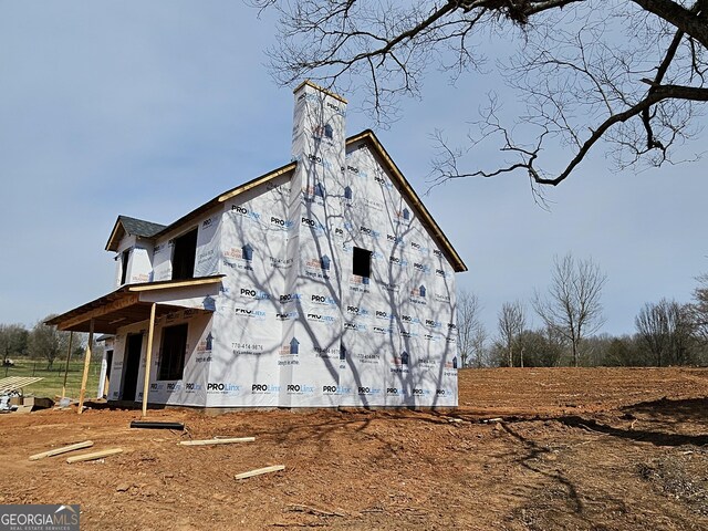 view of side of home featuring a chimney