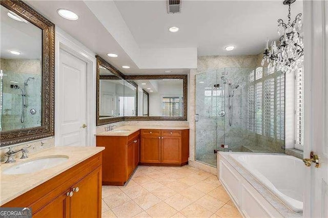 bathroom with plenty of natural light, a shower stall, visible vents, and a sink