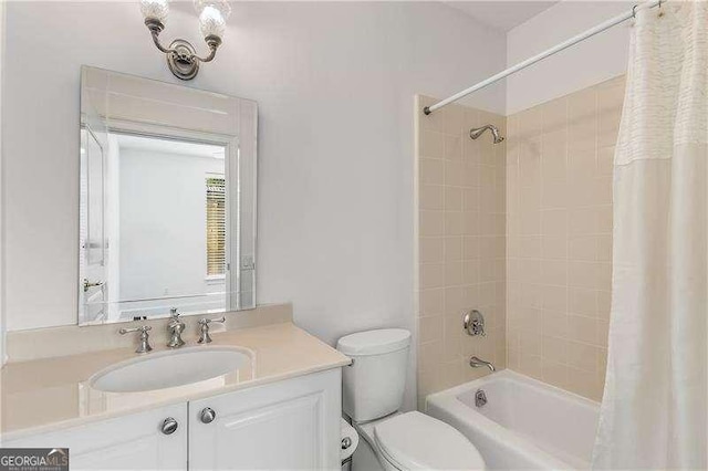 full bath featuring toilet, shower / bath combo with shower curtain, and vanity