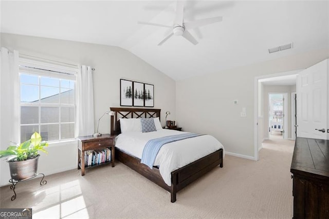 bedroom with lofted ceiling, baseboards, light carpet, and visible vents