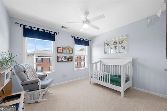 carpeted bedroom with visible vents, ceiling fan, and baseboards