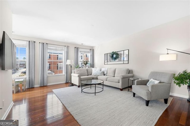 living area with baseboards and hardwood / wood-style flooring