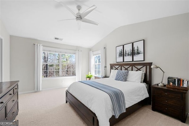 bedroom featuring lofted ceiling, light carpet, visible vents, and a ceiling fan