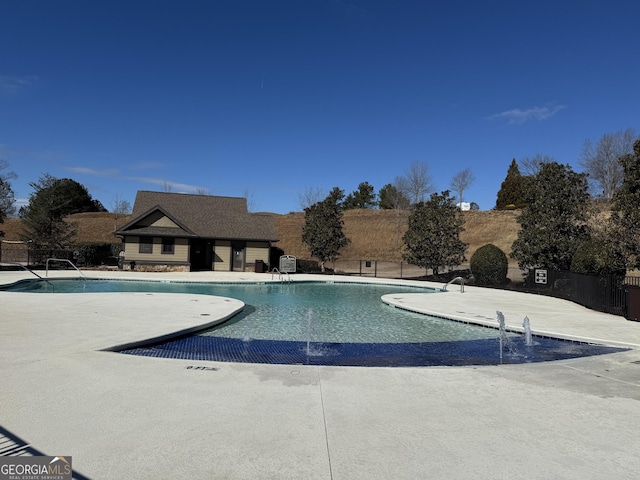 community pool featuring a patio and fence