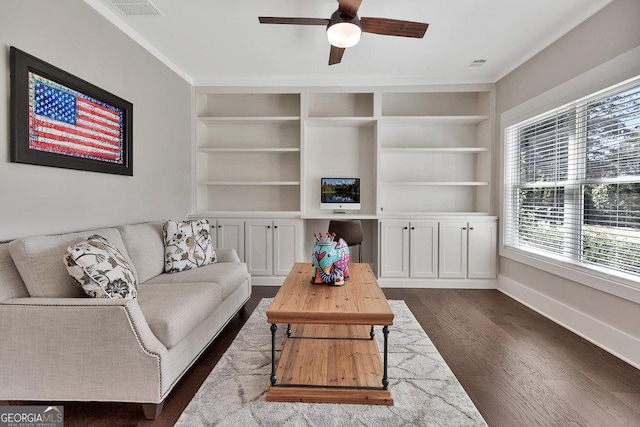 living area featuring dark wood-style flooring, built in features, visible vents, and baseboards